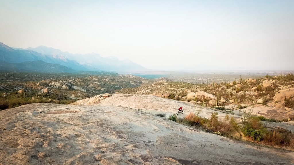 Rider carving granite slabs on the Cowboy Slickrock trail near Tucson, Arizona