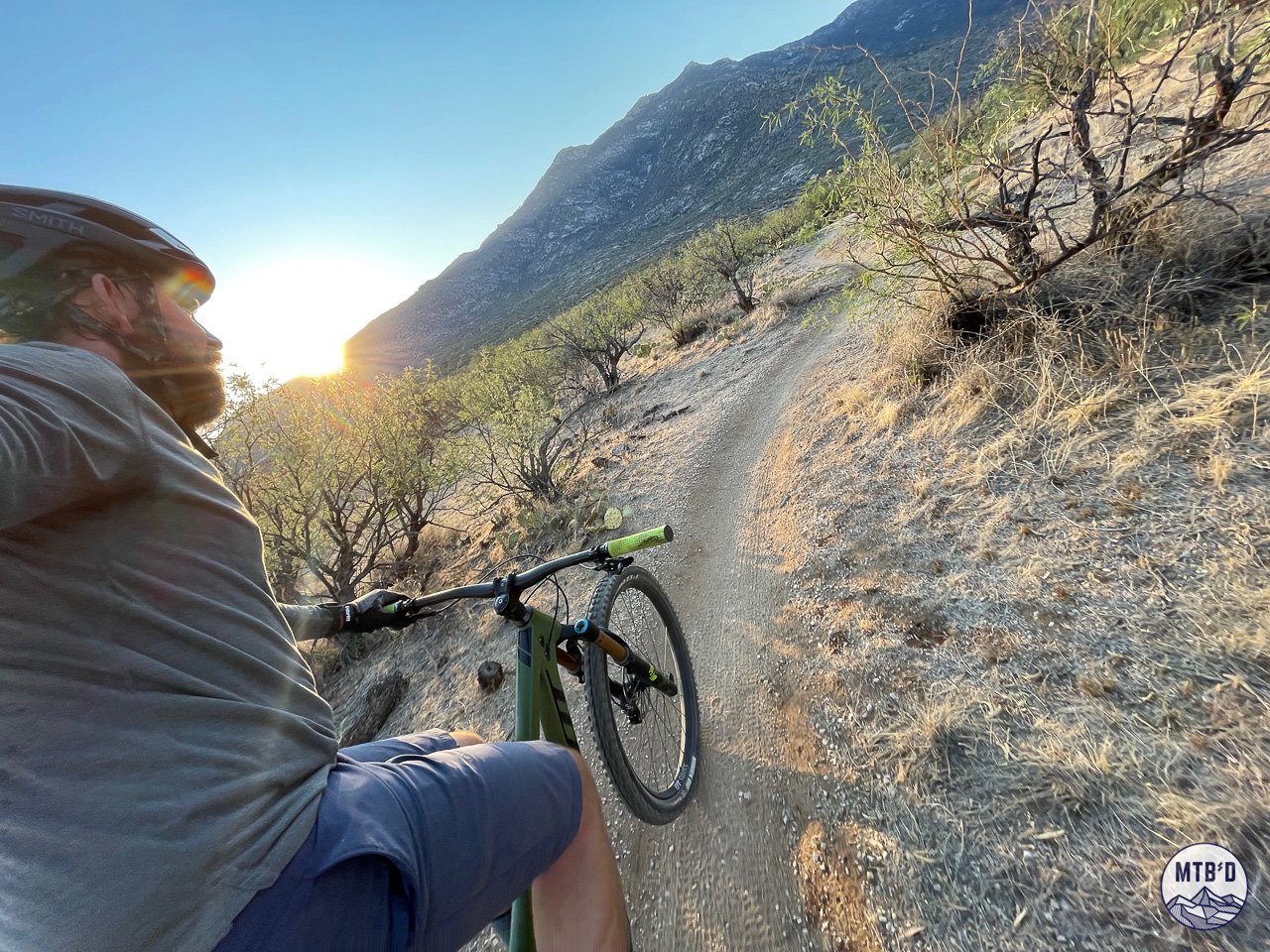 Rider on 50 Year Trail singletrack at sunrise with Santa Catalina Mountains in background near Tucson Arizona