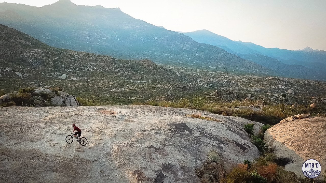 Aerial view of mountain biker riding exposed slickrock on Cowboy Slickrock trail at Golder Ranch, Tucson Arizona