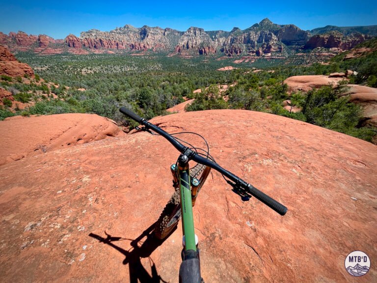 Mountain bike handlebars on High on the Hog Trail looking out over Sedona red rock formations, Arizona