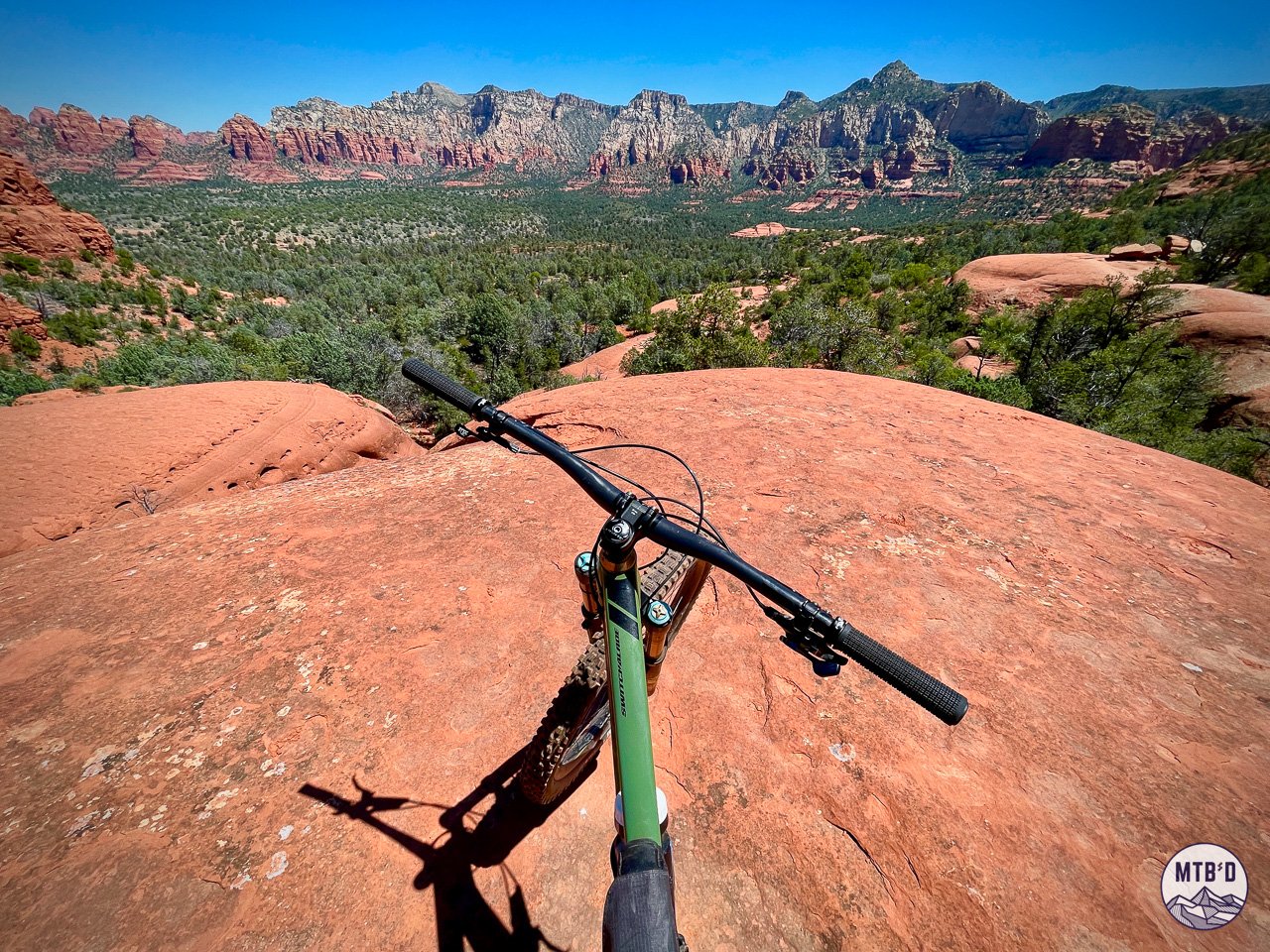 Mountain bike handlebars on High on the Hog Trail looking out over Sedona red rock formations, Arizona