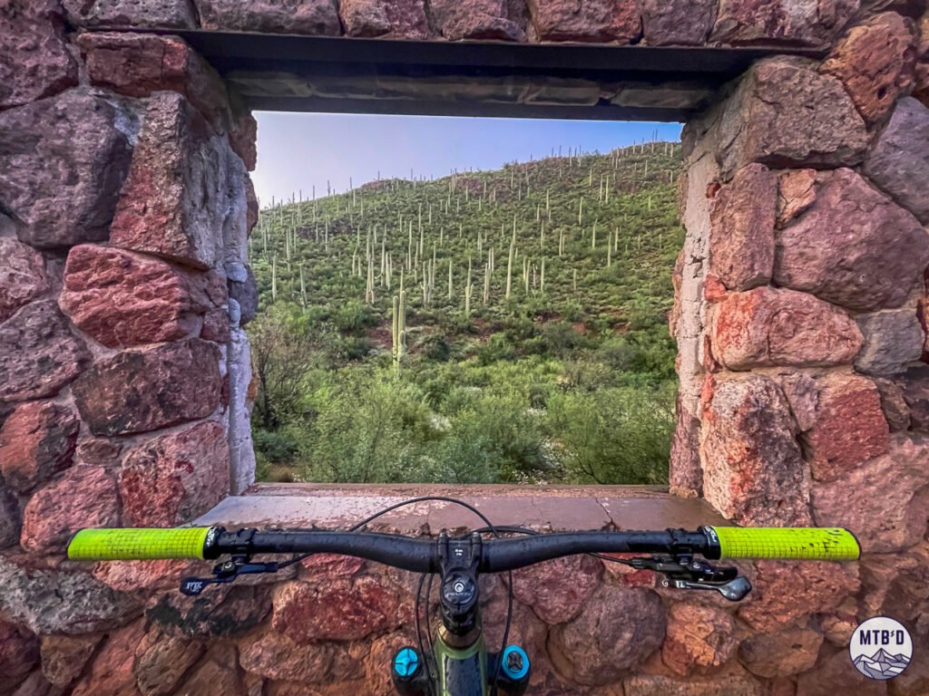 Bowen Stone House at Tucson Mountain Park, looking out a window over mountain bike handlebars